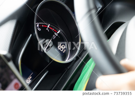 A view of a speedometer in a moving car, close up. A view of a speedometer in a moving car, close up. 73739355