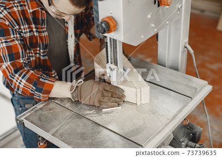 Carpenter working with circular saw Carpenter working with circular saw 73739635