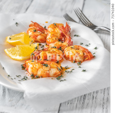 Shrimps with thyme and lemon wedges Shrimps with thyme and lemon wedges 73741040
