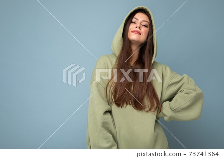 Young beautiful woman looking at camera. Trendy girl in casual hipster hoodie clothes. Positive Young beautiful woman looking at camera. Trendy girl in casual hipster hoodie clothes. Positive 73741364