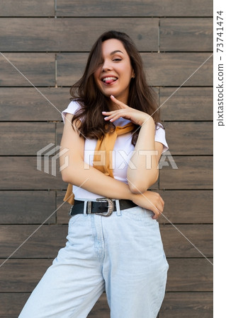 Vertical photo of emotional positive happy joyful pretty young brunette woman in trendy outfit Vertical photo of emotional positive happy joyful pretty young brunette woman in trendy outfit 73741474