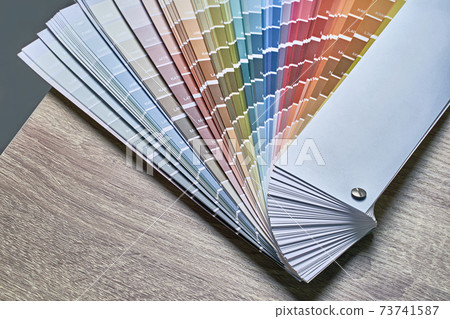 Color wheel palette for choosing paint tone. Various colors on wooden table background with copy space. Interior designer tool. Color wheel palette for choosing paint tone. Various colors on wooden table background with copy space. Interior designer tool. 73741587