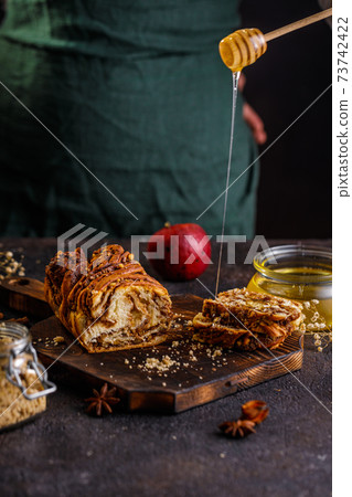 Swirl brioche or traditional Polish babka cake with walnut, apple and honey 73742422