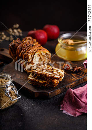 Swirl brioche or traditional Polish babka cake with walnut, apple and honey 73742425