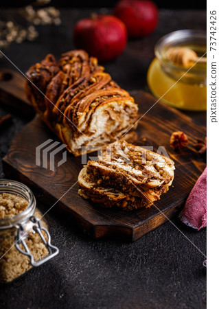 Swirl brioche or traditional Polish babka cake with walnut, apple and honey 73742426