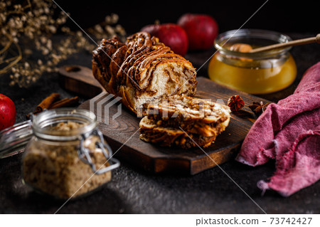 Swirl brioche or traditional Polish babka cake with walnut, apple and honey 73742427