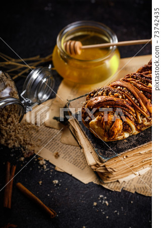 Swirl brioche or traditional Polish babka cake with walnut, apple and honey 73742435