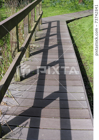Recycled plastic boardwalk path in parkland 73742841