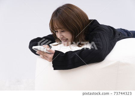 Woman using a smartphone Woman using a smartphone 73744323