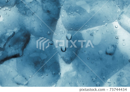 Ice cubes as background texture closeup photo 73744434