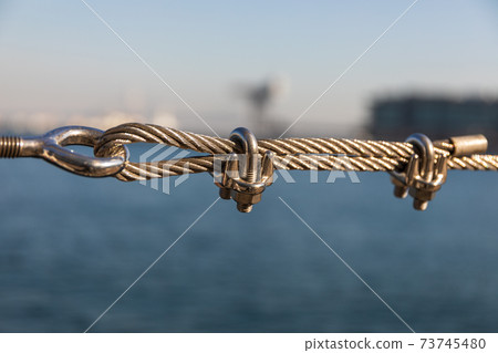 Clip metal fittings to stop the wire, close-up Clip metal fittings to stop the wire, close-up 73745480