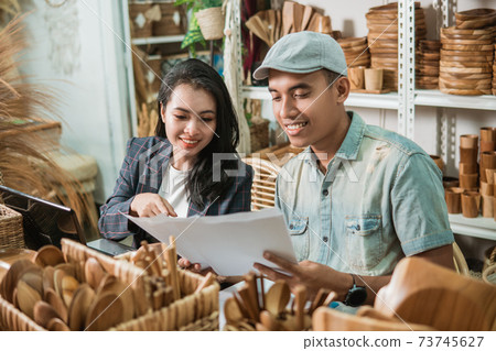 young man and woman see handicraft designs on paper young man and woman see handicraft designs on paper 73745627