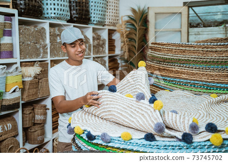 man holding knit carpet craft in the craft gallery man holding knit carpet craft in the craft gallery 73745702