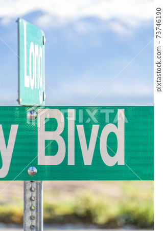 Selective focus on a green and white road street sign that reads Blvd 73746190