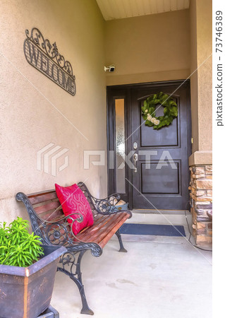 Entrance door to a house with rustic bench Entrance door to a house with rustic bench 73746389