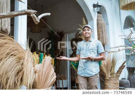 handicraft business owner with a hand gesture presents something 73746589