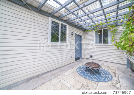 Paved patio with blue wooden pergola day light Paved patio with blue wooden pergola day light 73746907