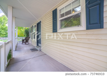 Long covered veranda in front of a timber house Long covered veranda in front of a timber house 73746910