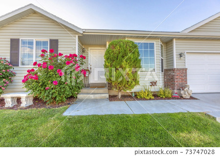 Exterior of one storey single family home with a beautiful front garden 73747028