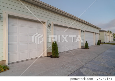 Receding line of closed garages on an estate 73747164