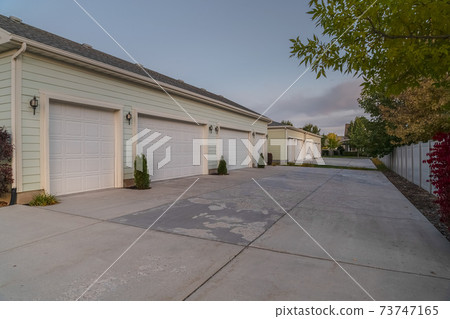 Receding row of garages on a housing estate 73747165