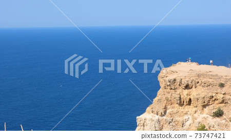 beach on cape Fiolent in Sevastopol, Crimea. View from the top of the rock. blue sea, sunny day beach on cape Fiolent in Sevastopol, Crimea. View from the top of the rock. blue sea, sunny day 73747421