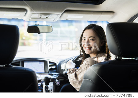 A young woman driving a car 73747893