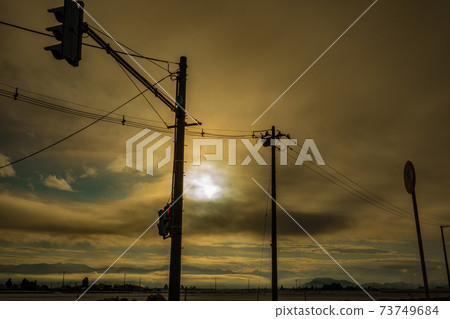 Sunrise and silhouette electric wire 73749684