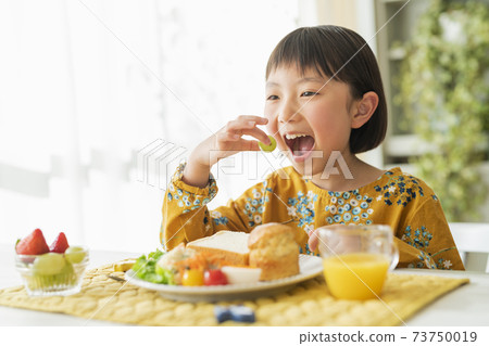 A girl who takes breakfast A girl who takes breakfast 73750019