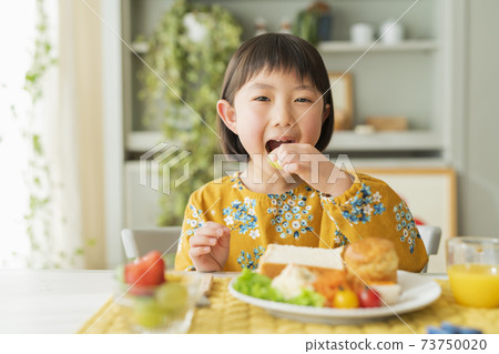 A girl who takes breakfast A girl who takes breakfast 73750020