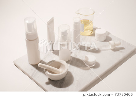 cosmetic and skin care for beauty routine on white background with shadow. modern and minimal product design with essential oil, pestle and mortar. cosmetic and skin care for beauty routine on white background with shadow. modern and minimal product design with essential oil, pestle and mortar. 73750406