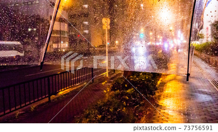 通過乙烯基傘看到的雨夜景 通過乙烯基傘看到的雨夜景 73756591