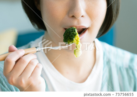 Woman eating vegetable food 73756655