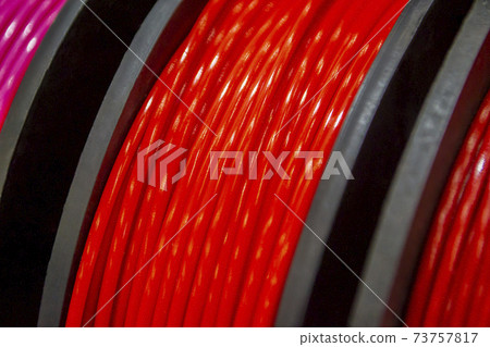 Multicolored filaments of plastic for printing on 3D printer close-up Multicolored filaments of plastic for printing on 3D printer close-up 73757817