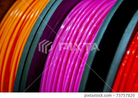 Multicolored filaments of plastic for printing on 3D printer close-up Multicolored filaments of plastic for printing on 3D printer close-up 73757820