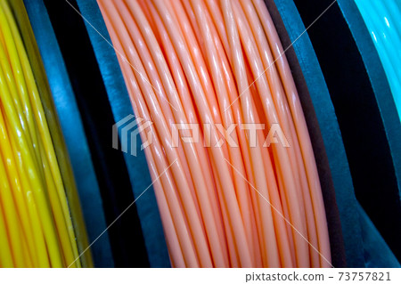 Multicolored filaments of plastic for printing on 3D printer close-up Multicolored filaments of plastic for printing on 3D printer close-up 73757821