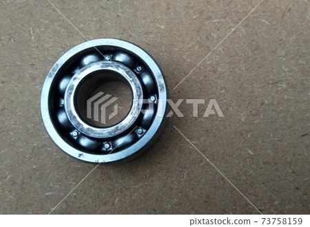 Used bearings, gaskets, screws and some other mechanical components of engines isolated on the high-pressure timber board. Used bearings, gaskets, screws and some other mechanical components of engines isolated on the high-pressure timber board. 73758159