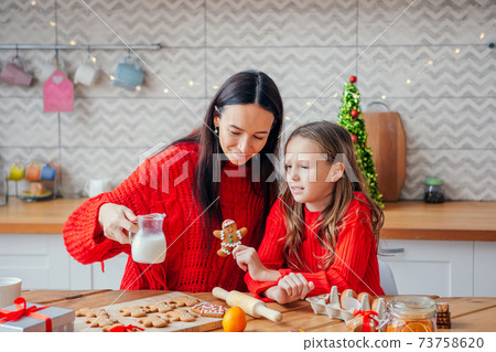 Happy family mother and daughter bake cookies for Christmas Happy family mother and daughter bake cookies for Christmas 73758620