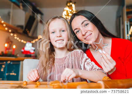Happy family mother and daughter bake cookies for Christmas Happy family mother and daughter bake cookies for Christmas 73758621