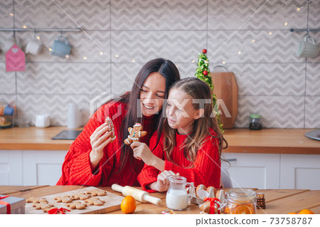 Happy family mother and daughter bake cookies for Christmas Happy family mother and daughter bake cookies for Christmas 73758787