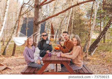 Happy family on a picnic in the park at autumn Happy family on a picnic in the park at autumn 73759015