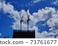 Crane silhouette in dynamic clouds 73761677
