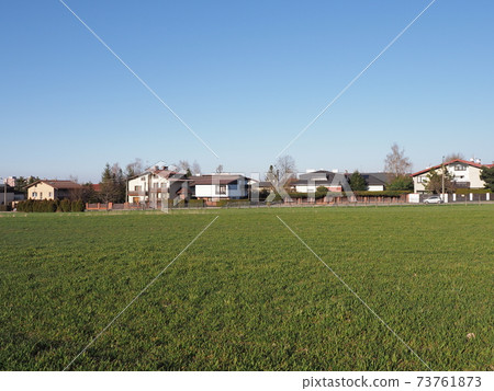 Green field and houses in Bielsko-Biala city, Poland 73761873