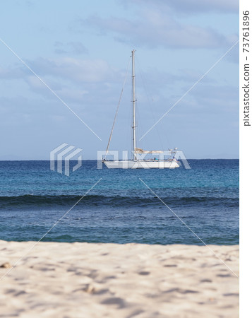 Beach with yacht on Atlantic Ocean, Sal island, Cape Verde - vertical 73761896