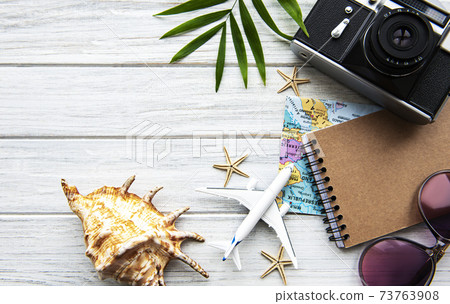 Traveler accessories on wooden background Traveler accessories on wooden background 73763908