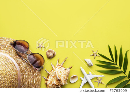 Traveler accessories on yellow background Traveler accessories on yellow background 73763909