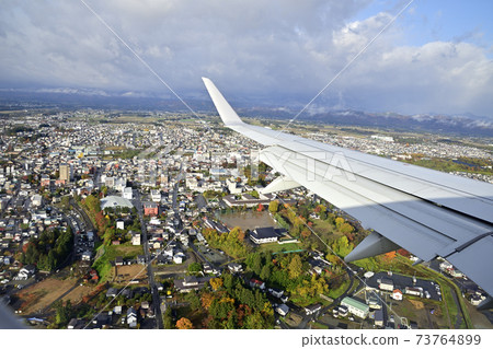 From the sky above Hanamaki to the city of Hanamaki in late autumn 73764899
