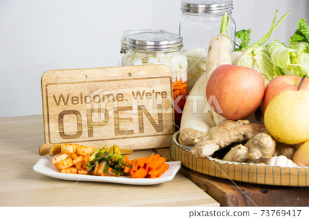 open sign on the table with fruits and vegetables 73769417