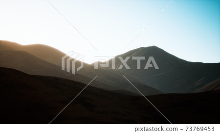 hills with rocks at sunset 73769453
