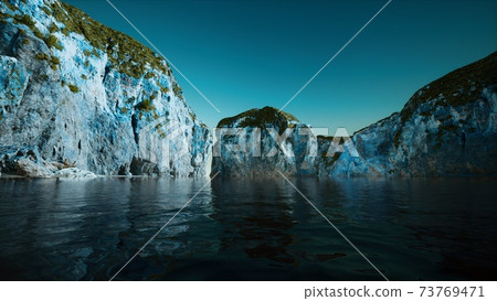 rocky cliff at cold sea water rocky cliff at cold sea water 73769471